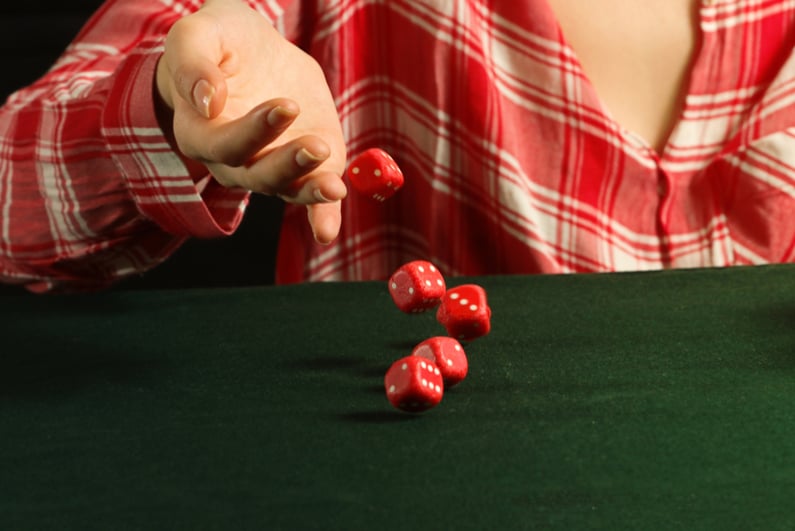 Woman rolling red dice