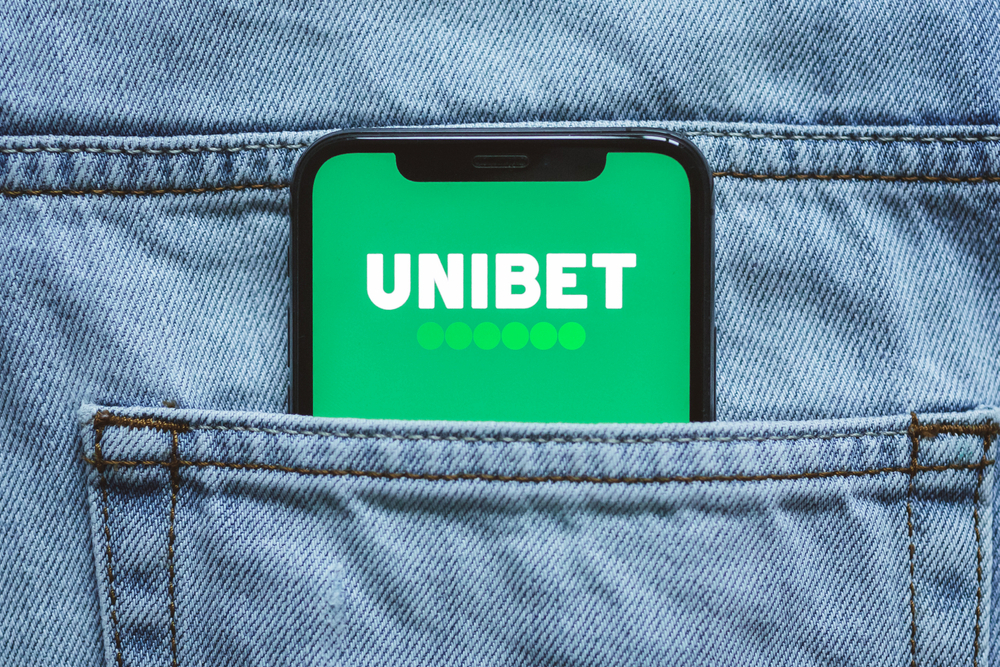 Unibet logo on phone screen in pocket